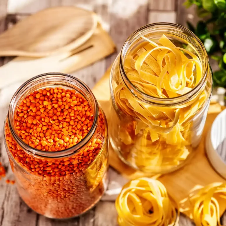 Produktaufnahme mit zwei Vorratsgläsers mit roten Linsen und Tagliatelle auf einem Holztisch in Vogelperspektive. Studio für Produktfotografie Klaus Ohlenschlaeger, Frankfurt-Kronberg
